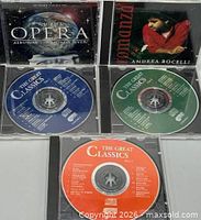 All five jewel cases open showing covers and three The Great Classics discs