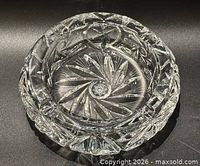 Top view of round cut crystal ashtray displaying pinwheel pattern