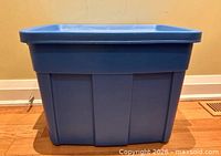 Side view of blue Rubbermaid Roughneck storage bin