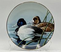 Front view of plate showing artwork and gold rim