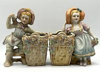 Front view of both ceramic figurine planters