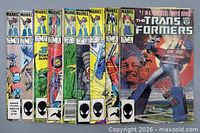 Group shot of all nine Transformers comics, covers visible