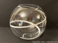Front view of clear spherical vase showing white swirl
