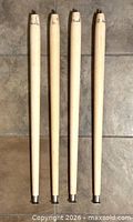 Four wood table legs side by side showing full length