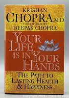 Front cover showing title, author, and lotus design