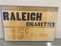 Front view of Raleigh Cigarettes poster showing full text and colors