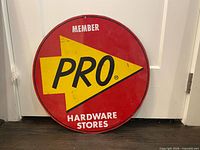 Front of round Pro Hardware metal sign showing graphics