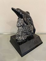front view of black soapstone sculpture on base