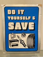 Front of cardboard sign showing "Do It Yourself & Save" with automotive part illustrations