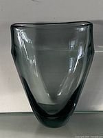 Front view of smoke grey asymmetrical glass vase