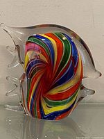 Front view of Murano glass fish showing rainbow spiral and clear fins