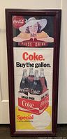 Front view of framed Coca-Cola poster