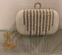 Front view of pearl covered clutch with chain strap