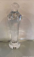 Full view of clear glass figurine standing upright