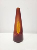 Full frontal view of cone-shaped dark orange vase