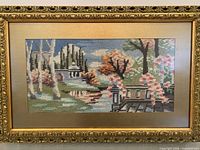 Front view of framed needlepoint showing entire image and frame