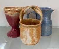 Front view of three pottery pieces grouped together