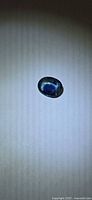 Top view of loose oval blue sapphire