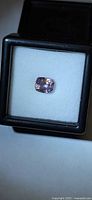 Cushion-cut pink purple spinel in gem box