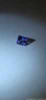 Top view of square princess cut Tanzanite on neutral background