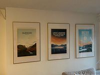 Three framed posters on wall showing overall lot