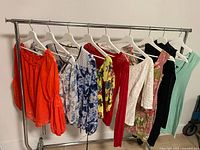 Full rack showing ten garments on hangers
