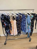 Full rack view of eight dresses on hangers