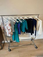 Full rack of eight garments on hangers