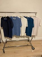 Full view of six Lululemon shirts on rack