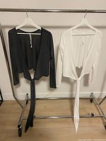 Both Lululemon cropped tops on rack, grey left, white right