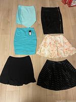 Six skirts laid out on floor
