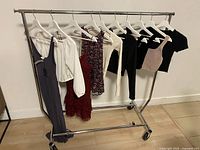Full rack of eight garments on white hangers