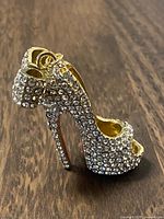 Side view of gold-tone rhinestone high heel shoe keychain