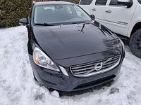 Front view of black 2012 Volvo S60 showing grille, headlamps, hood condition
