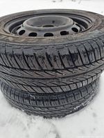 Three-quarter view of both tires stacked, showing tread and rims