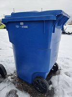 Side view of one blue 95-gallon recycling bin with wheels and hinged lid