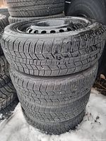 Stack of four General tires on steel rims showing tread depth