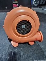 Front view showing intake mesh, housing, and feet