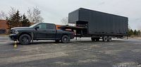 Side view of black 5th wheel trailer hitched to pickup