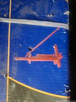 Graphic illustration of red tire changer on blue box