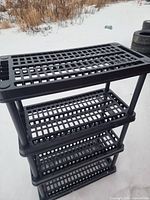 Front angled view of black plastic 3-tier rack