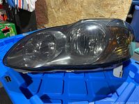 Front view of one Corolla headlight showing lens clarity and housing
