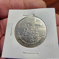 Reverse of 1984 Jacques Cartier Canadian dollar in holder