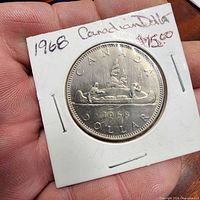 Reverse of 1968 Canadian dollar in holder