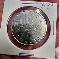 Obverse side of 1986 Canadian 1 dollar coin in holder