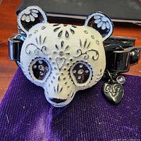 Front view showing panda head with rhinestone eyes and heart charm