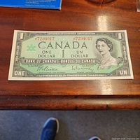 Front of 1967 Canadian Centennial $1 bill showing serial number and Queen Elizabeth II portrait