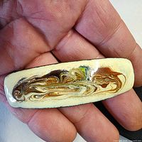 Front view showing abstract enamel design and cream border