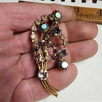 Full view of brooch in hand showing overall design and size