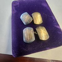 Front view of both cufflinks on velvet pad